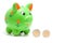 Green piggy bank with coins