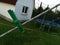 Green pin on rope with house and trampoline in background