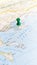 A green pin stuck in the island of Thasos on a map of Greece portrait