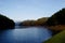 Green pine forest with camping of tourist near the lake with fog over the water in the morning, Pang oung Maehongson province nort