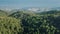 Green pine tree forest in mountain wild nature landscape, aerial view. Sunlight dense wood highland