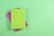 Green and pink hardcover books on green background