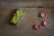 Green and pink scented candles on wooden background