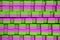 Green and pink sports mats stacked in large stack