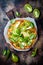 Green pizza with pesto, zucchini, tomatoes, avocado, jalapeno, mozzarella cheese and fresh basil.