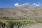 Green places for the tent camp in the background of the ice cap on the summit of the snow-capped volcano Mount Ararat Agri Dagi