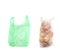 Green plastic bag and reusable recycled mesh net grocery bag full of fresh apples, comparison on white background, concept of zero