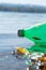 A green plastic bottle floats down the river. The river is very polluted and the bottle should be recycled