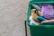 Green plastic box filled with a pile of old, colorful, worn out brushes for grooming horses - Horizontal, Copy space