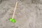 green plastic childrens toy shovel on a sand