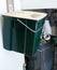 Green plastic container for food waste/scraps. Kitchen trash cabinet. Recycling/composting
