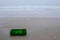 Green plastic container washed up on the beach on the Oystercatcher Trail, near Mossel Bay, Garden Route, South Africa