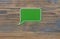 green plastic speech bubble on wood background