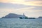 Green platform supply vessels or crews boat sail pass islands near coastal