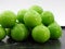 Green plums on white background