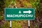 Green pointing sign to Machupicchu