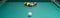 Green pool table, pyramid of balls to play, white ball to hit.