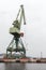 Green port crane, close-up vertical photo