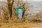 Green portable toilet with dirty white door