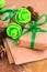 Green presents wrapped in natural paper on old wood