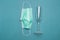 Green protection face mask for corona virus or covid 19 prevention white alcohol drinking glass in restaurant on paper background