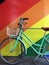 Green Pushbike and Rainbow Wall