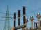 Green pylon, High Voltage circuit-breaker and current transformers at blue sky background