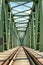 Green railroad bridge rails