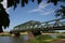 Green railway bridge over the river on a sunny day