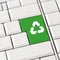 Green recycle icon on a computer keyboard