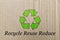 Green recycling arrow icon on waste packaging paper, recycle reuse and reduce to protect environment