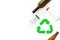 Green recycling sign with waste materials, bottles for ecology save concept on white background top view copyspace