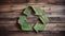 Green Recycling Symbol on wooden background, environment, ecology, Earth day concept