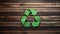 Green Recycling Symbol on wooden background, environment, ecology, Earth day concept