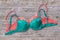 Green and red bras on wooden background.
