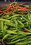 Green and red chili on a counter top of a store during food festival market