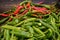 Green and red chili on a counter top of a store during food festival market