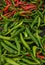 Green and red chili on a counter top of a store during food festival market