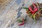 Green and red chili on wicker basket on wood table, ingredient for many kinds of spice foodChili peppers on old wooden