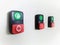 Green and red electrical button switches in a white background