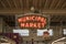 A green and red neon Municipal Market sign inside a white buildings with lights in Atlanta Georgia