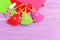 Green, red and pink Christmas trees crafts, scissors, white thread, needle, felt sheets set on a lilac wooden background