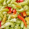 Green and reddish horn organic  peppers top view closeup