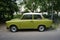 Green retro car Trabant is parked on the roadside. The first European vintage car. Berlin, Germany