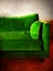 Green retro sofa in a room