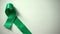 Green ribbon on table, World Mental health day, awareness campaign, tolerance