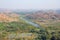 Green rice fields, palms and river Tungabhadra in the village of Hampi. Palm trees, the sun, rice fields. Tropical exotic