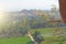 Green rice fields or terraces in the village of Hampi and the Temple of Virupaksha. Palm trees, sun, rice fields, large stones.