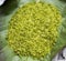 Green rice flakes Com in Vietnamese. Com is freshly harvested sticky glutinous/sweet rice that`s been toasted to bring out i