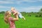 On green rice terraces background mother tossing joyful baby boy